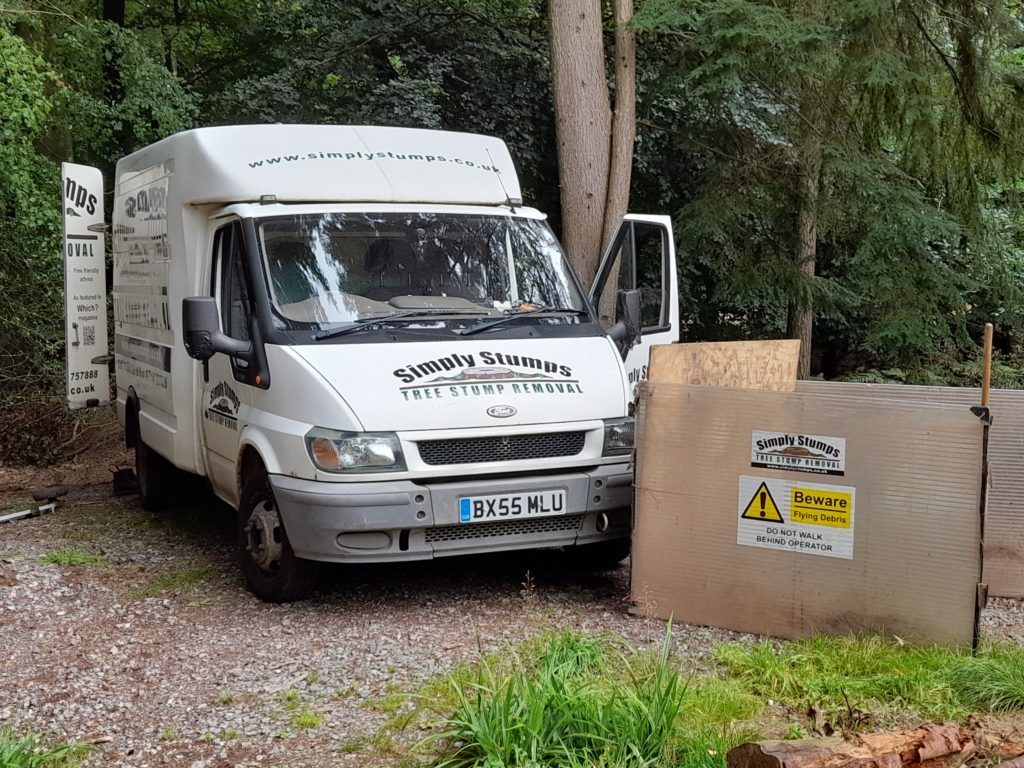 Photo showing the Simply Stumps van and shields in a woodland setting